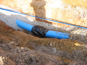 Water line poly-wrapped at the bend and ready for concrete thrust block