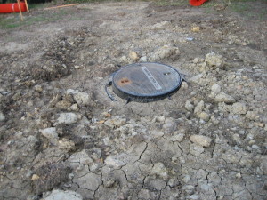 Sewer manhole after backfilling